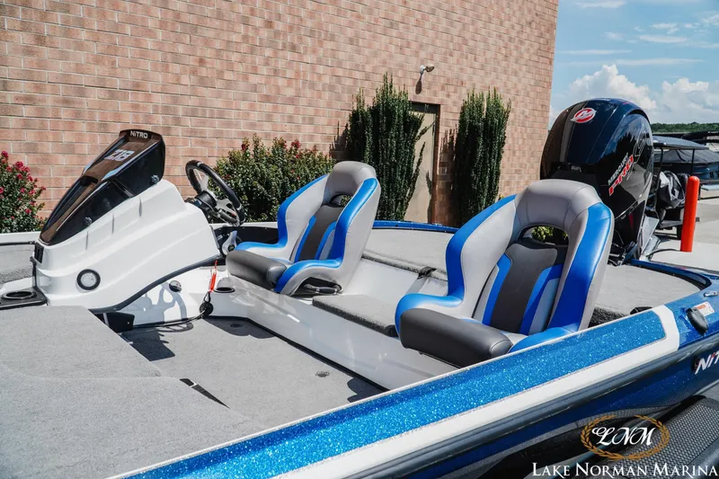 Slide: The Image of 2025 Nitro Z18 Pro boat with blue and gray seating, displayed at Lake Norman Marina. - 4