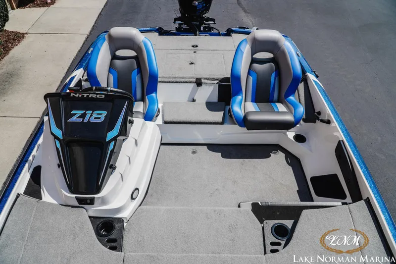 Slide: The Image of 2025 Nitro Z18 Pro boat with blue and gray seating at Lake Norman Marina. - 12