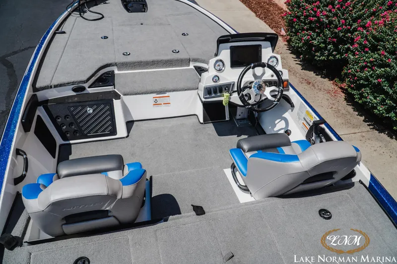 Slide: The Image of 2025 Nitro Z18 Pro boat interior with dual seats and steering console at Lake Norman Marina. - 8