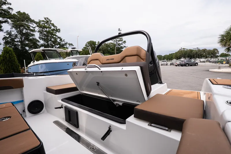 Slide: The Image of 2027 Sea Pro 245FLXR Sandbar boat with open storage compartment and cushioned seating. - 15