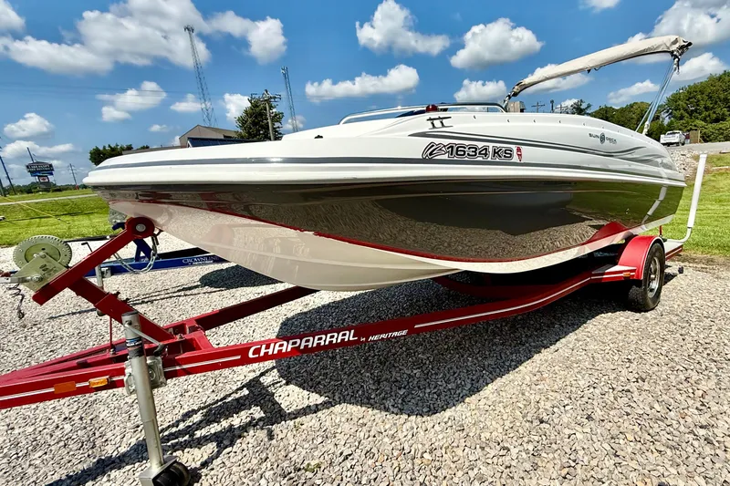 The Image of 2014 Hurricane SunDeck Sport 188 OB boat on Chaparral trailer, parked on gravel. - 1
