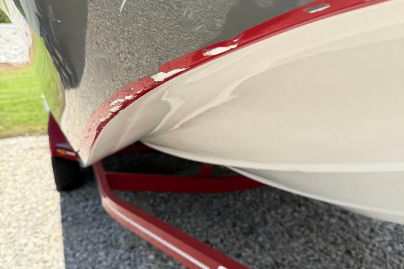 Slide: The Image of 2014 Hurricane SunDeck Sport 188 OB boat on red trailer, showing hull detail. - 17