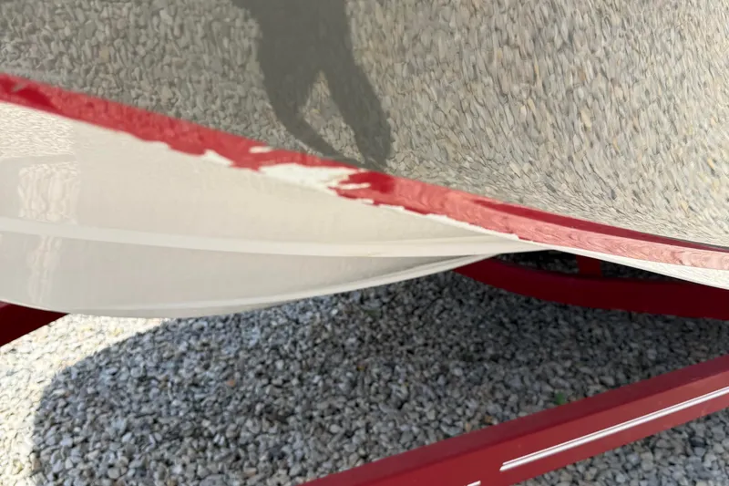 Slide: The Image of 2014 Hurricane SunDeck Sport 188 OB boat hull with red paint damage. - 16