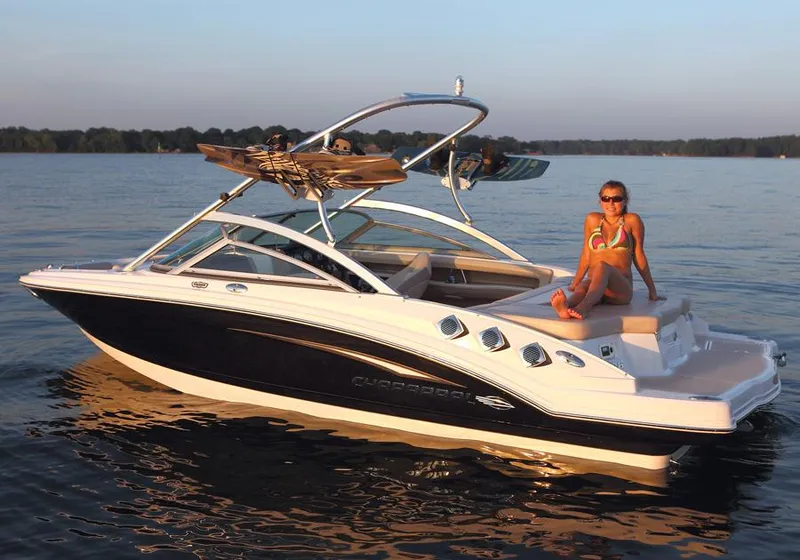 Slide: The Image of Manufacturer Provided Image: 2012 Chaparral 196 SSi boat on a lake with a person relaxing. - 20
