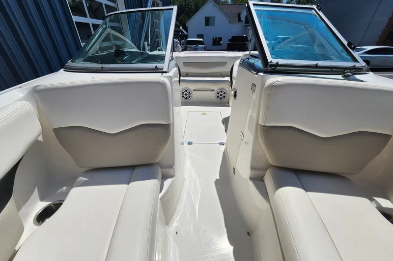 Slide: The Image of Interior view of a 2012 Chaparral 196 SSi boat with white seating and open windshield. - 14