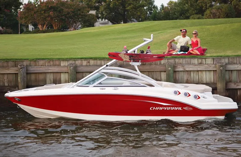 Slide: The Image of Manufacturer Provided Image: Chaparral 196 SSi 2012 boat docked by grassy shore with people relaxing. - 21