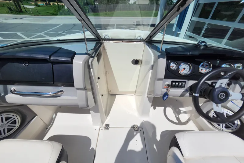 Slide: The Image of 2012 Chaparral 196 SSi boat interior with steering wheel, dashboard, and seating. - 17