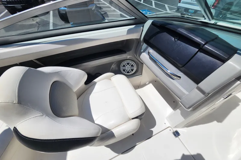 Slide: The Image of Interior of 2012 Chaparral 196 SSi boat, featuring white seating and dashboard. - 11