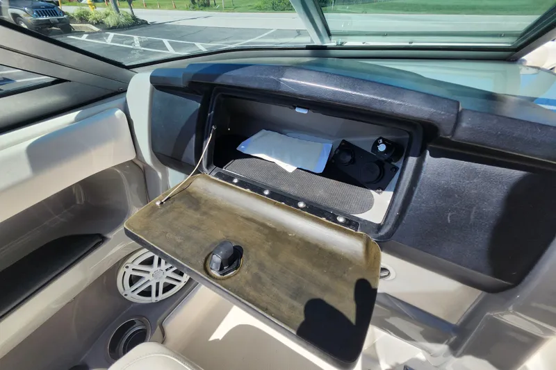 Slide: The Image of Open glove compartment in 2012 Chaparral 196 SSi boat interior, showing storage space. - 12