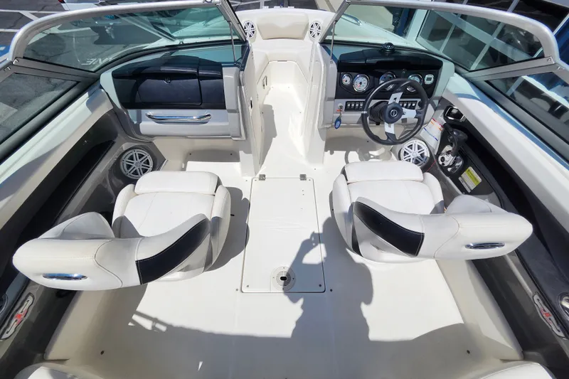 Slide: The Image of Interior of a 2012 Chaparral 196 SSi boat with white seating and dashboard. - 8
