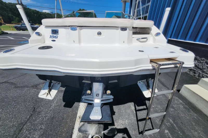 Slide: The Image of 2012 Chaparral 196 SSi boat rear view with swim platform and ladder. - 2