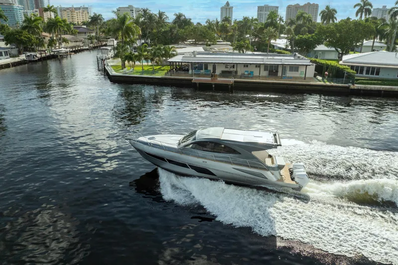 Slide: The Image of 2025 Valiatt 410HT yacht cruising on a scenic waterway with palm trees and buildings. - 14