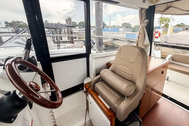 Slide: The Image of Interior of 2016 Jeanneau Merry Fisher 855 boat with steering wheel and captain's chair. - 24