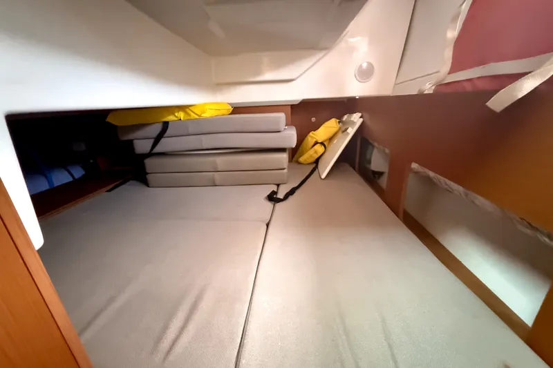 Slide: The Image of Interior cabin of 2016 Jeanneau Merry Fisher 855 with cushions and storage. - 31