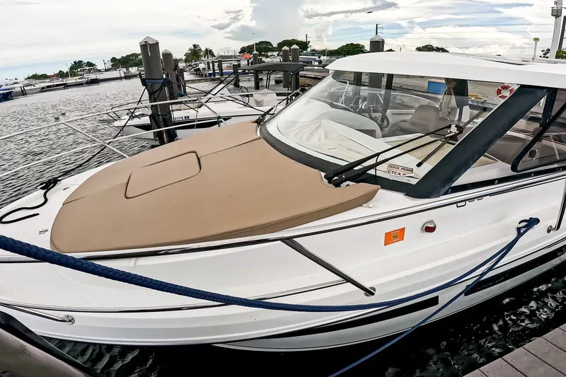 Slide: The Image of 2016 Jeanneau Merry Fisher 855 docked at marina, featuring sleek design and spacious deck. - 6