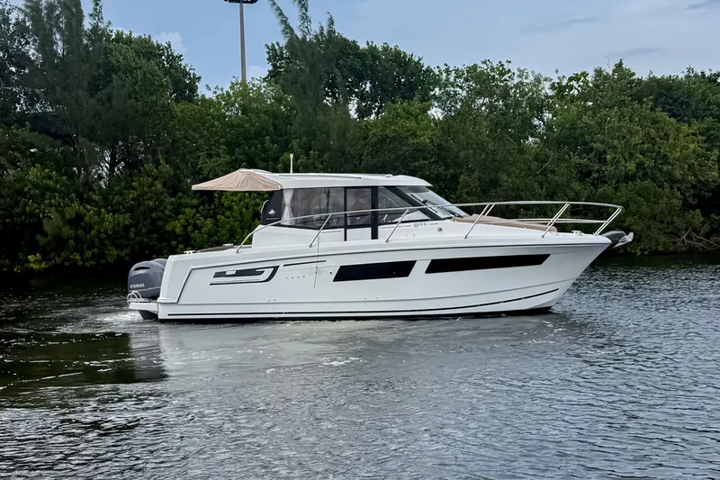 Slide: The Image of 2016 Jeanneau Merry Fisher 855 boat cruising on a calm river. - 3