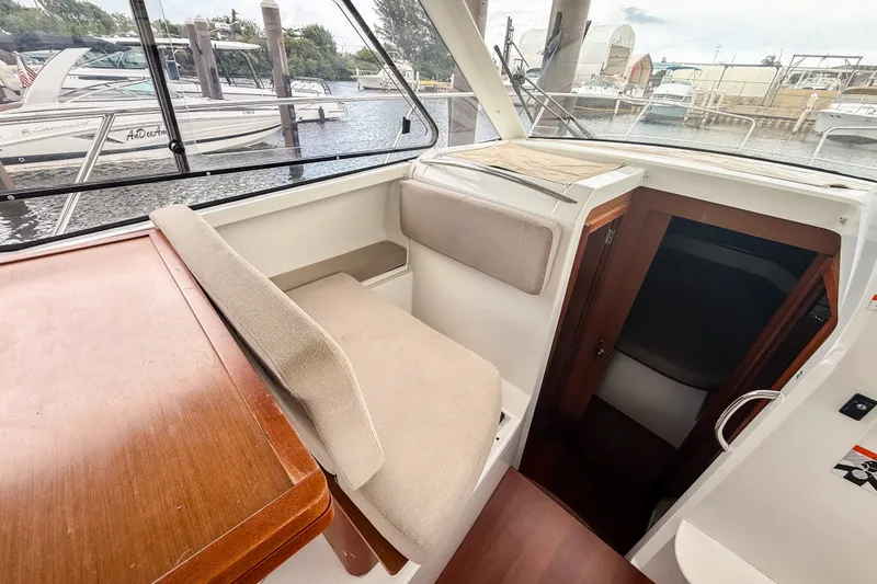 Slide: The Image of Interior view of 2016 Jeanneau Merry Fisher 855 boat, featuring seating and cabin entrance. - 14