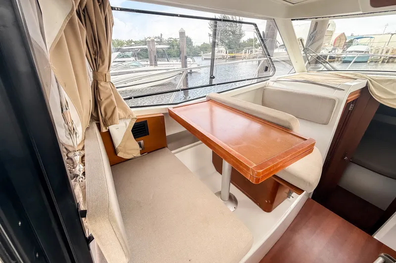 Slide: The Image of Interior of 2016 Jeanneau Merry Fisher 855 with dining area and window view. - 13