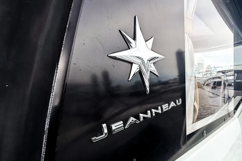 Slide: The Image of Jeanneau Merry Fisher 855 emblem on a 2016 model boat, featuring a star logo. - 34