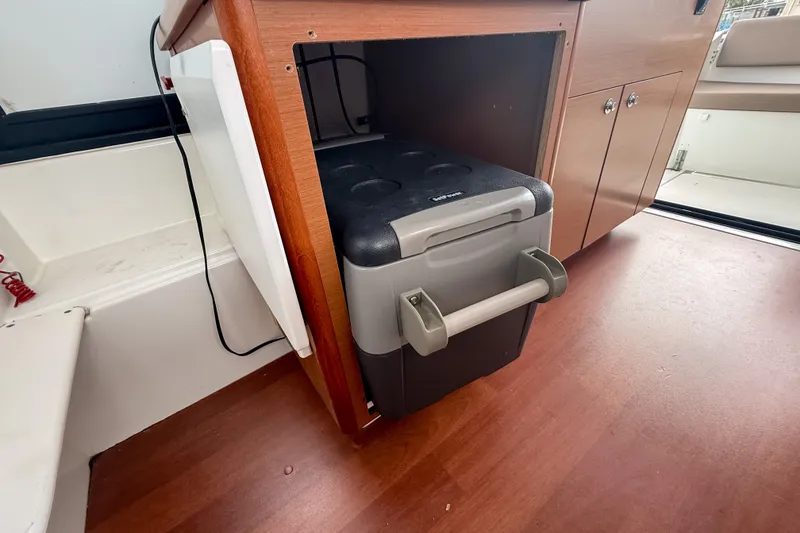 Slide: The Image of Compact cooler storage in 2016 Jeanneau Merry Fisher 855 boat interior. - 25