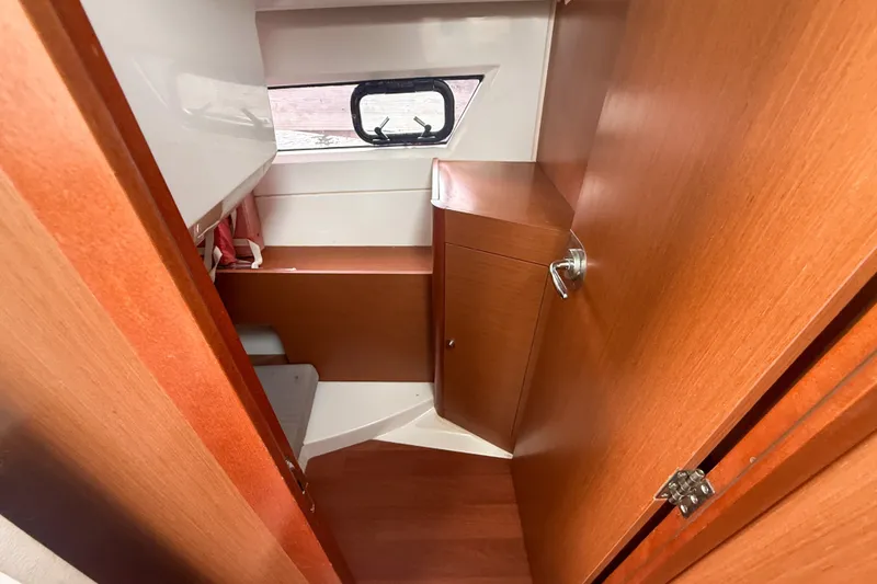 Slide: The Image of Interior cabin of 2016 Jeanneau Merry Fisher 855 with wooden finish and window. - 30