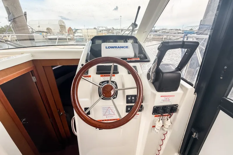 Slide: The Image of Steering console of 2016 Jeanneau Merry Fisher 855 with Lowrance navigation system. - 20