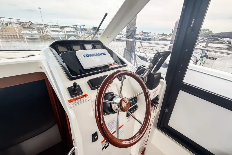 Slide: The Image of Helm of 2016 Jeanneau Merry Fisher 855 with Lowrance navigation system. - 23