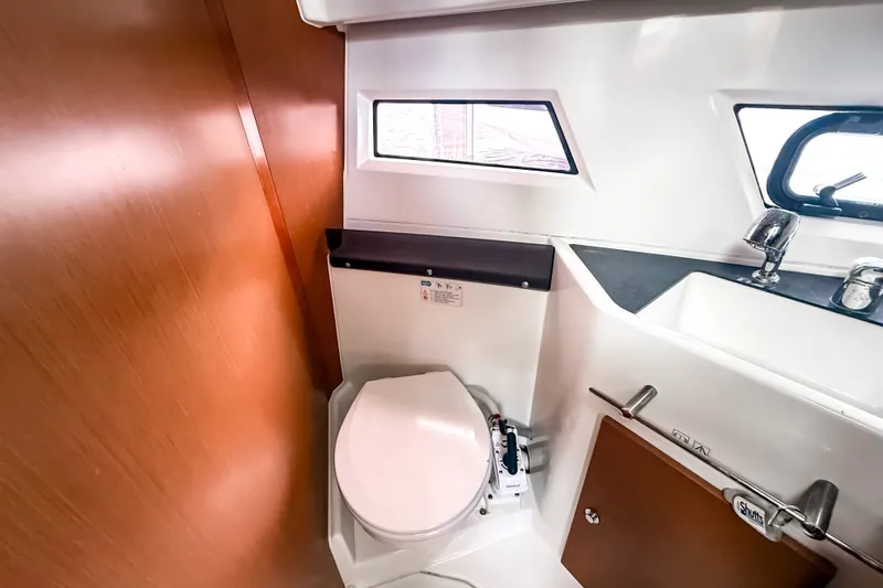 Slide: The Image of Compact bathroom in 2016 Jeanneau Merry Fisher 855 boat, featuring toilet and sink. - 29
