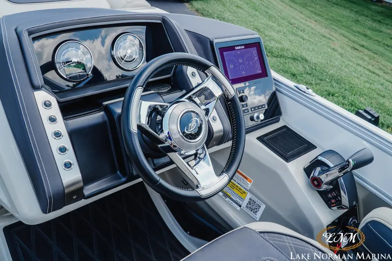 Slide: The Image of 2023 Barletta L550 boat dashboard with steering wheel and control panel. - 10