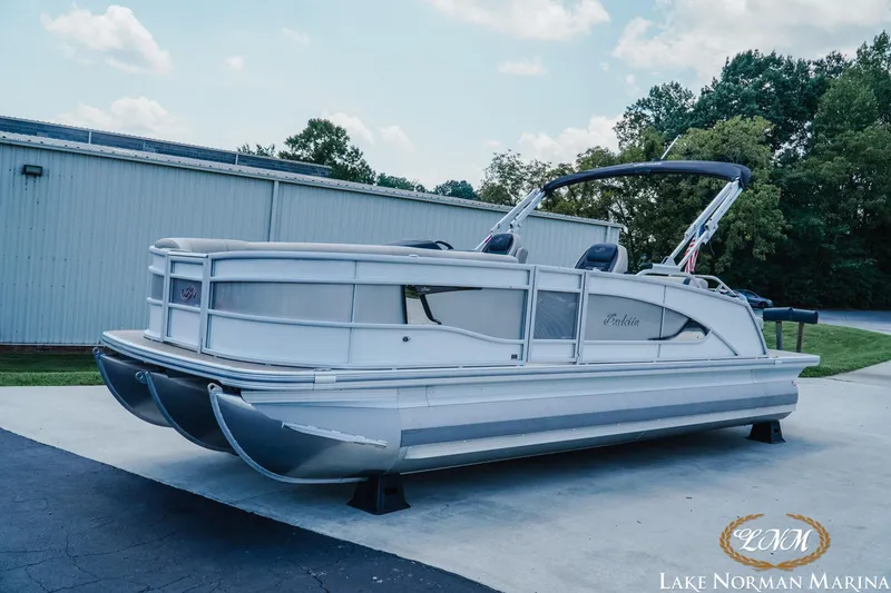 Slide: The Image of 2023 Barletta L550 pontoon boat at Lake Norman Marina, parked outdoors. - 2