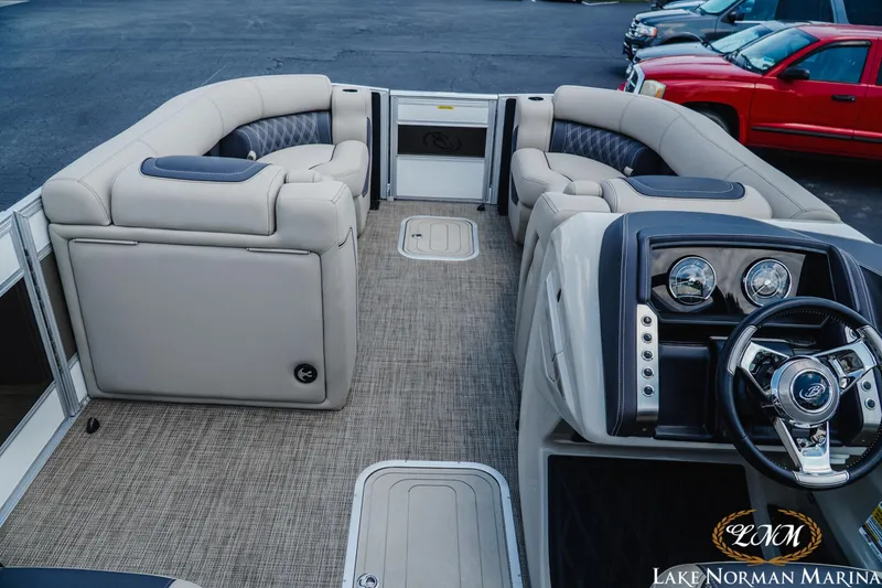 Slide: The Image of 2023 Barletta L550 boat interior with luxurious seating and modern dashboard at Lake Norman Marina. - 7