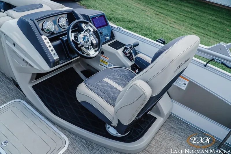 Slide: The Image of Captain's seat and dashboard of 2023 Barletta L550 boat at Lake Norman Marina. - 8
