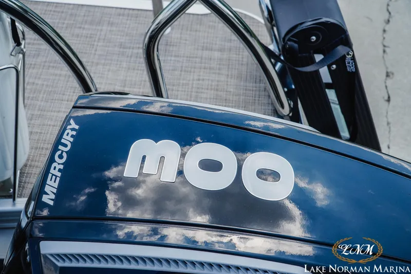 Slide: The Image of 2023 Barletta L550 boat with Mercury engine, reflecting clouds, at Lake Norman Marina. - 4