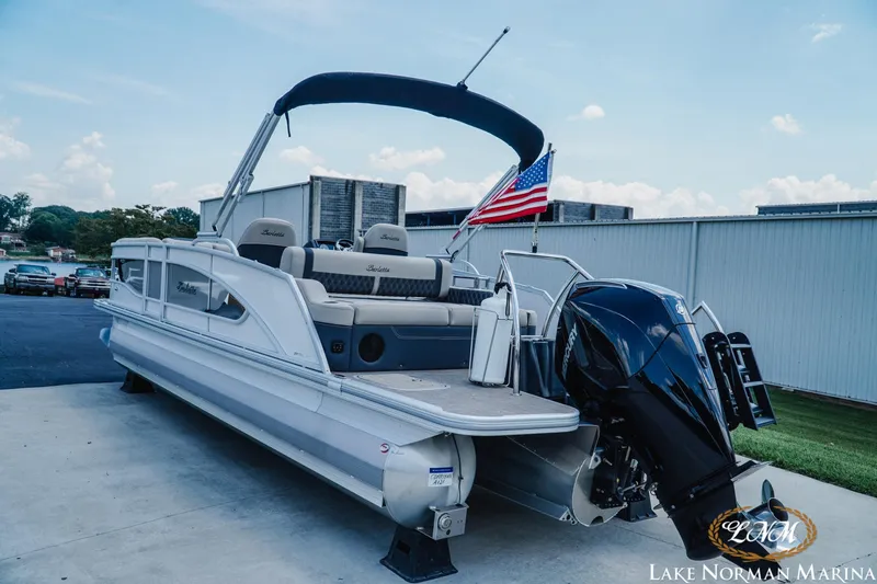Slide: The Image of 2023 Barletta L550 pontoon boat with American flag at Lake Norman Marina. - 3
