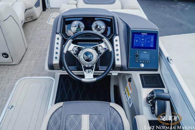 Slide: The Image of 2023 Barletta L550 boat dashboard with steering wheel and digital display at Lake Norman Marina. - 9