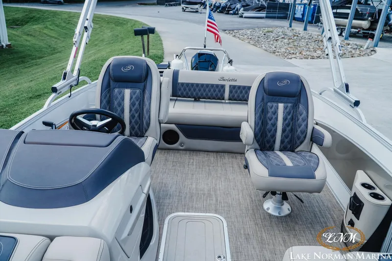 Slide: The Image of 2023 Barletta L550 boat interior with luxurious seating and steering wheel at Lake Norman Marina. - 15