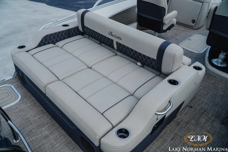 Slide: The Image of Luxurious seating on 2023 Barletta L550 boat, featuring beige upholstery and cup holders. - 6