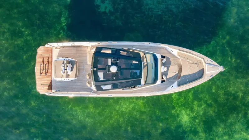 Slide: The Image of Aerial view of 2026 OKEAN 57 yacht on clear green water. - 48