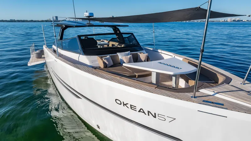 Slide: The Image of Luxurious 2026 OKEAN 57 yacht cruising on calm blue waters under a clear sky. - 41