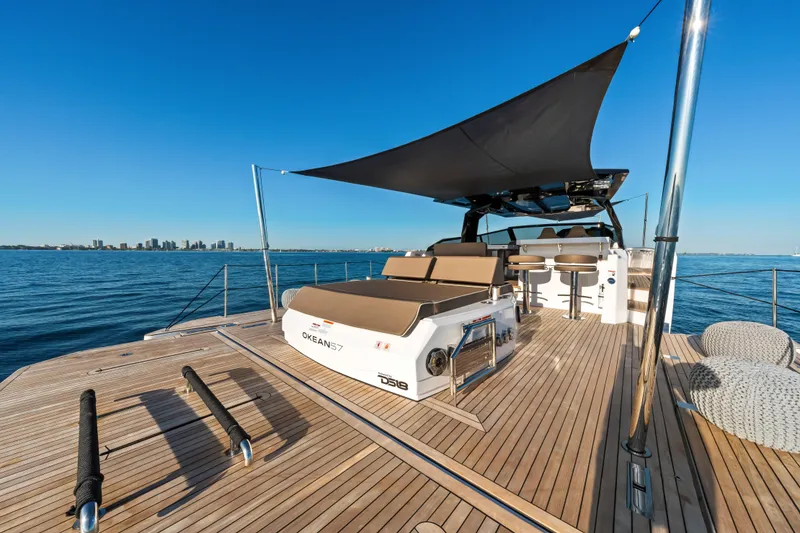 Slide: The Image of Luxury OKEAN 57 yacht, 2026 model, with spacious deck and sunshade on open water. - 35