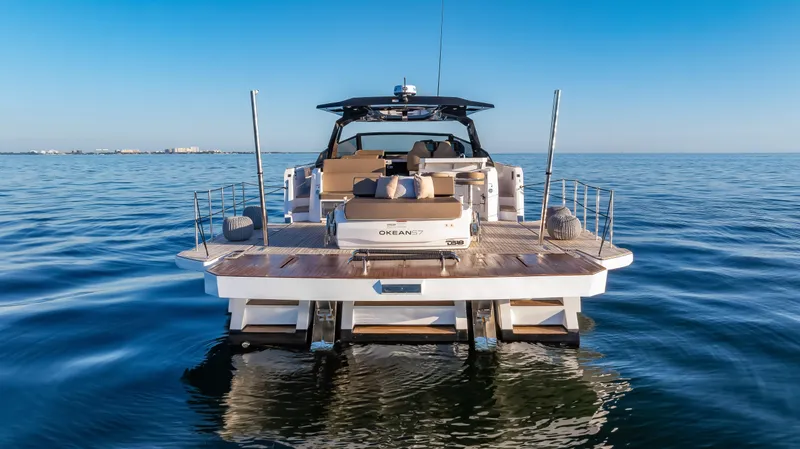 Slide: The Image of Luxury OKEAN 57 yacht on calm sea, showcasing modern design and spacious deck, 2026 model. - 30