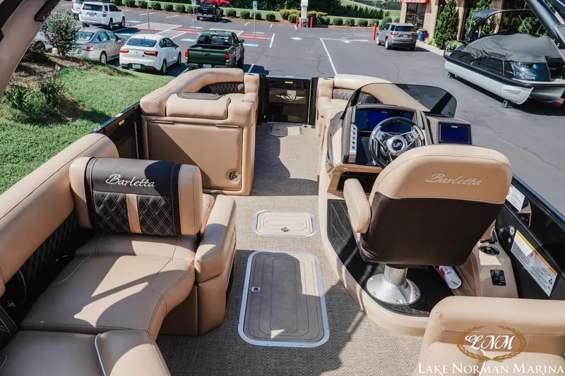 Slide: The Image of Luxurious 2025 Barletta L25MAT pontoon boat interior with plush seating and modern dashboard. - 8
