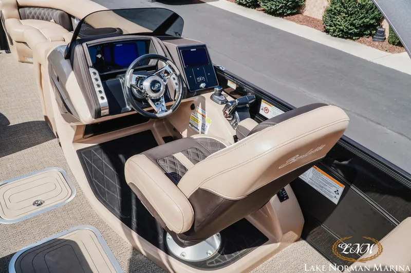Slide: The Image of 2025 Barletta L25MAT boat interior with luxurious seating and modern dashboard controls. - 9