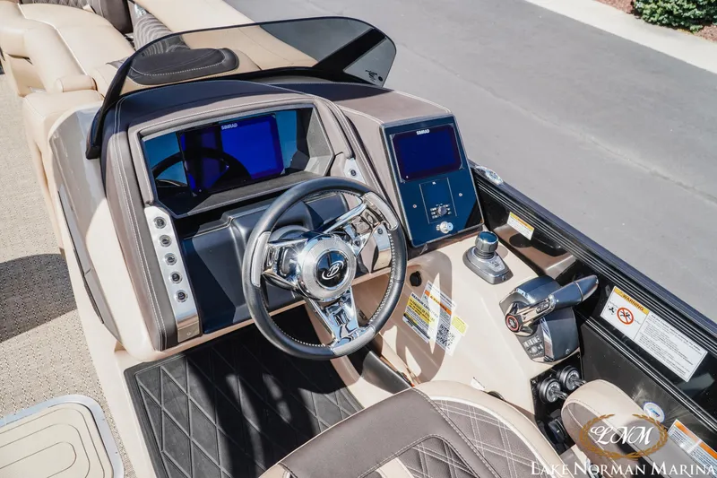 Slide: The Image of Cockpit of 2025 Barletta L25MAT boat with modern controls and steering wheel. - 10