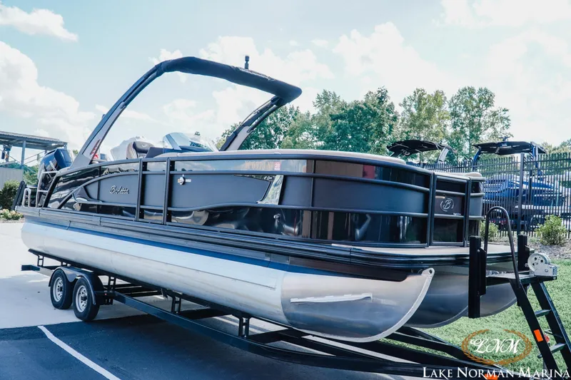 Slide: The Image of 2025 Barletta L25MAT pontoon boat on trailer at Lake Norman Marina. - 2
