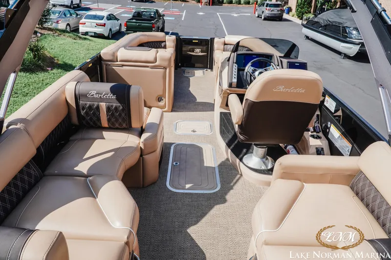 Slide: The Image of 2025 Barletta L25MAT pontoon boat interior with luxurious seating and modern helm. - 5