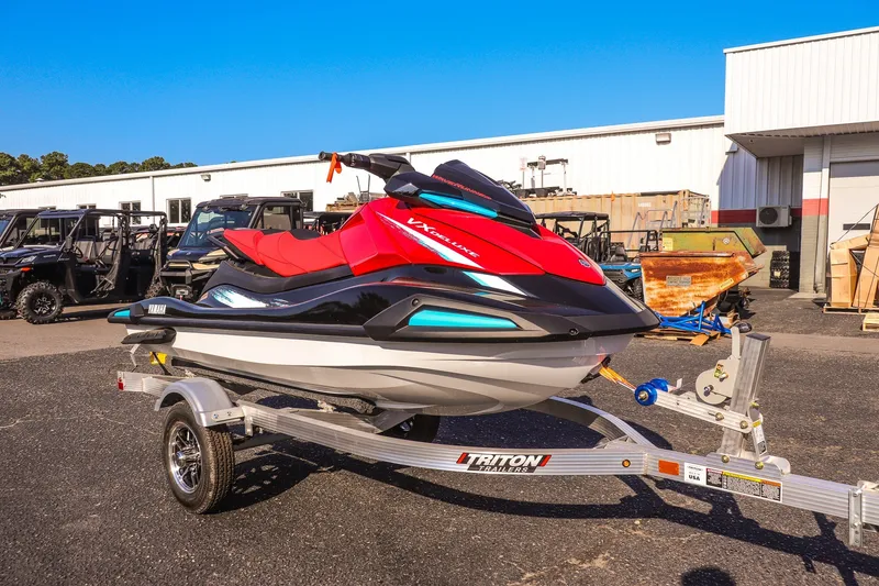The Image of 2026 Yamaha WaveRunner VX Deluxe on trailer, parked outdoors near industrial buildings. - 1