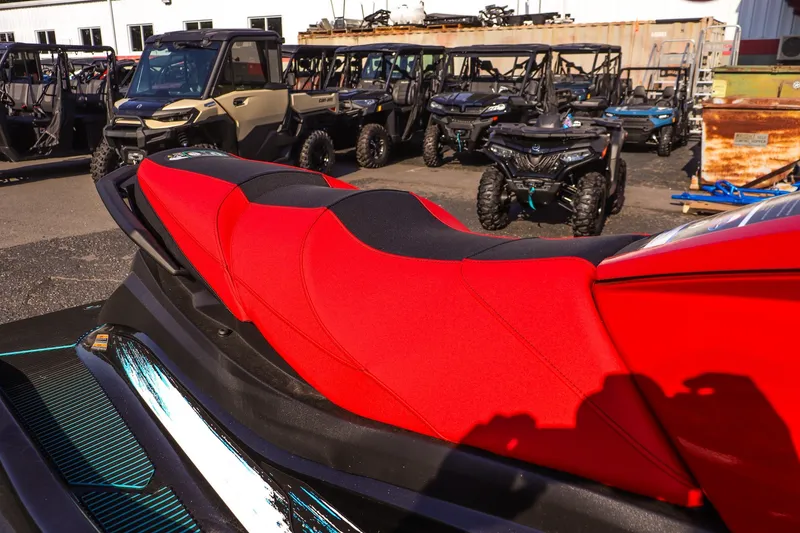 Slide: The Image of 2026 Yamaha WaveRunner VX Deluxe with red seat, parked among off-road vehicles. - 14