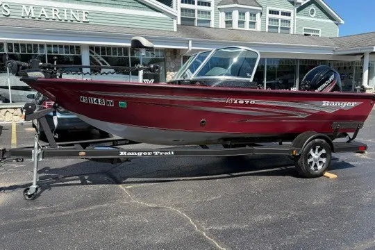 Slide: The Image of 2018 Ranger VS1670 SC boat on trailer, parked outside a marine store. - 2
