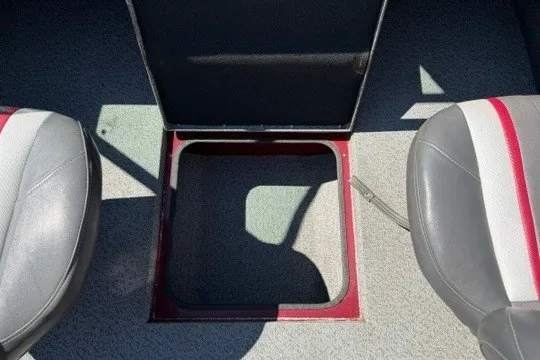 Slide: The Image of 2018 Ranger VS1670 SC boat interior with open storage compartment between seats. - 34